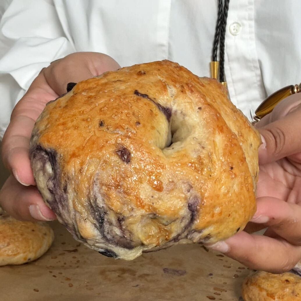 Homemade blueberry bagels with glossy crust and real blueberry streaks - Hungry Mockingbird