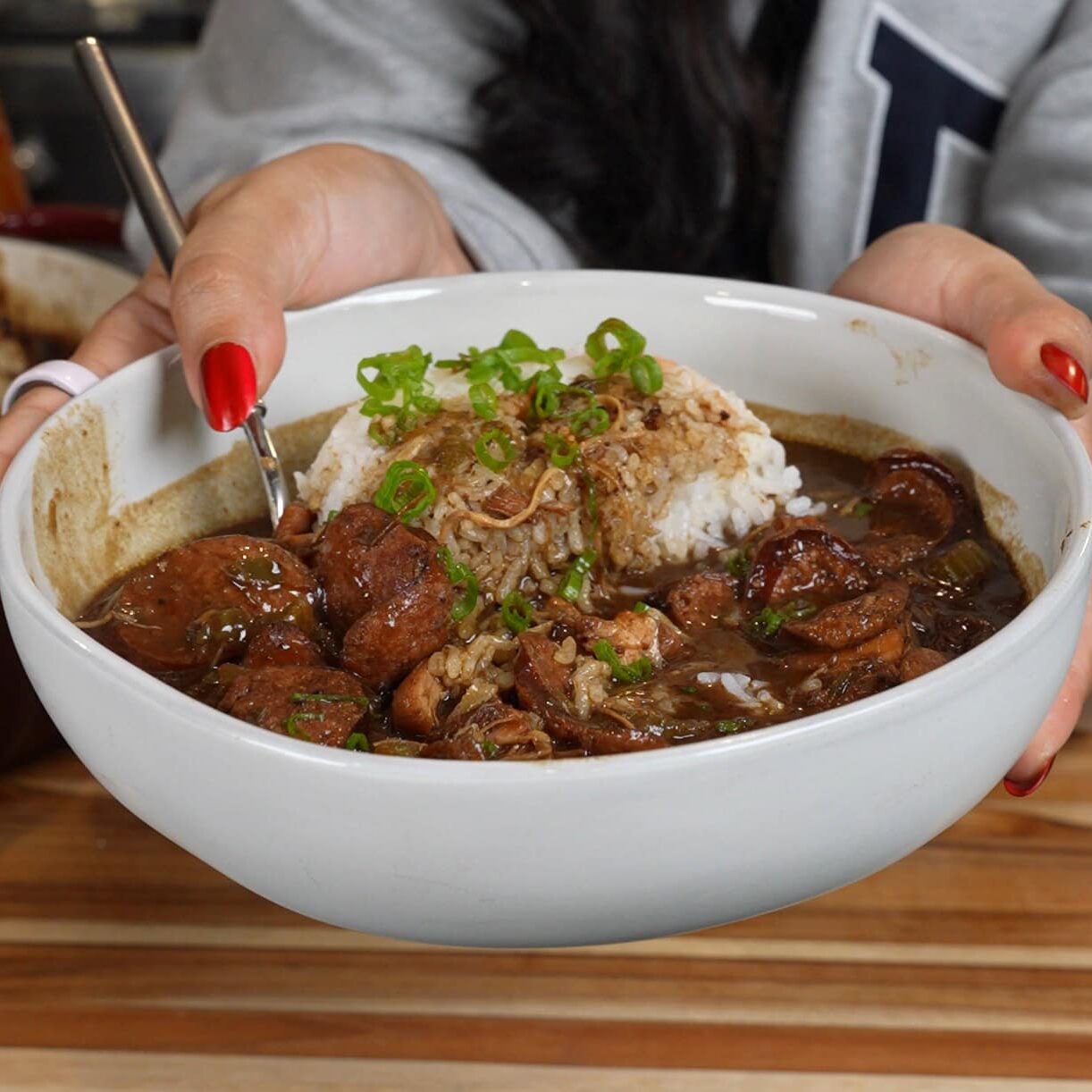 Bowl of dark roux chicken and andouille sausage gumbo over white rice - Hungry Mockingbird