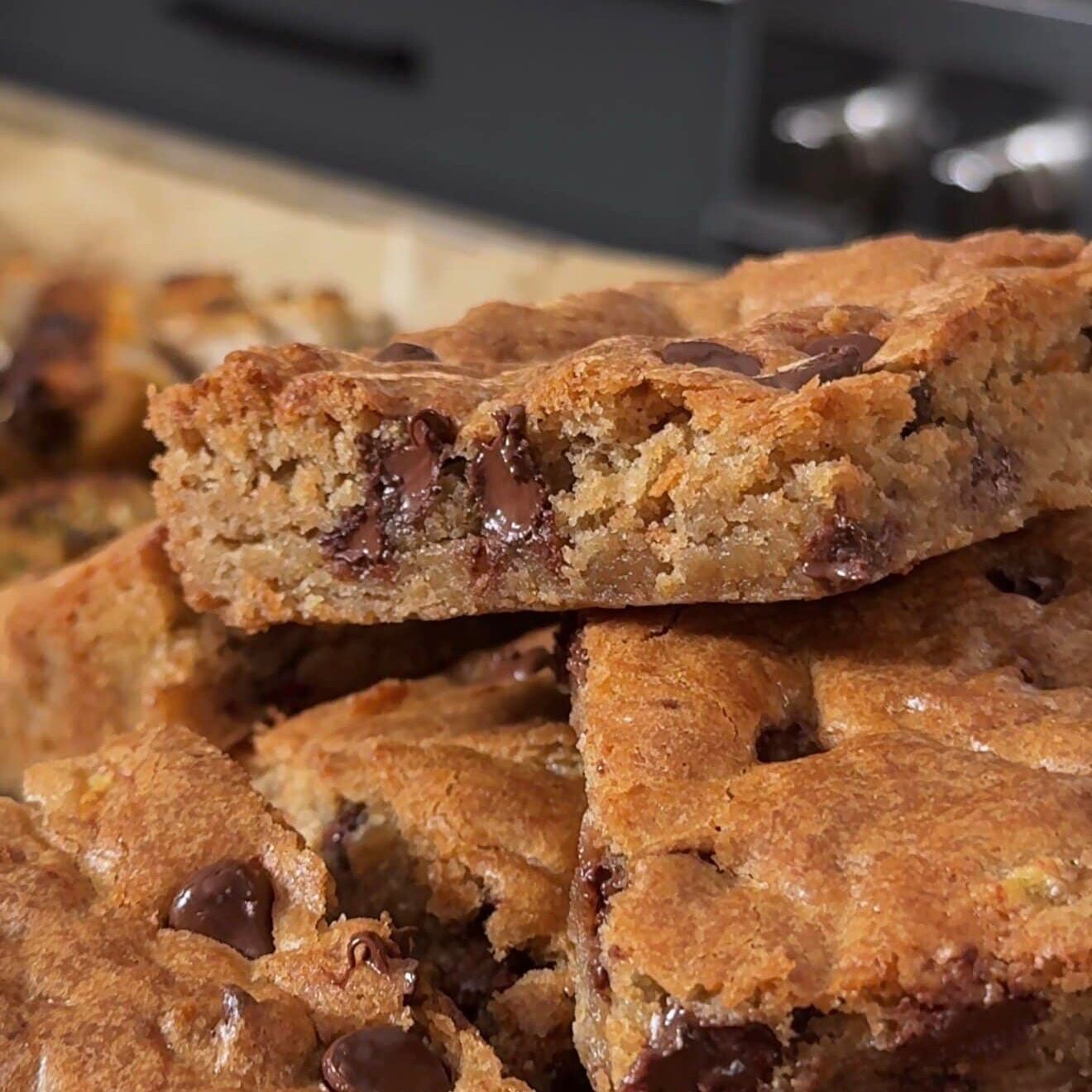 A stack of banana spice chocolate chip blondies with melty chocolate chips