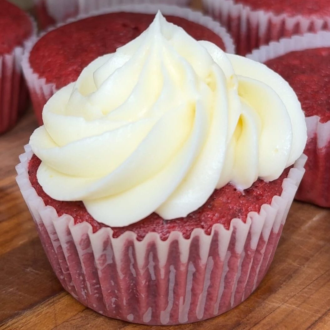 Red velvet cupcakes piped with homemade cream cheese frosting - Hungry Mockingbird