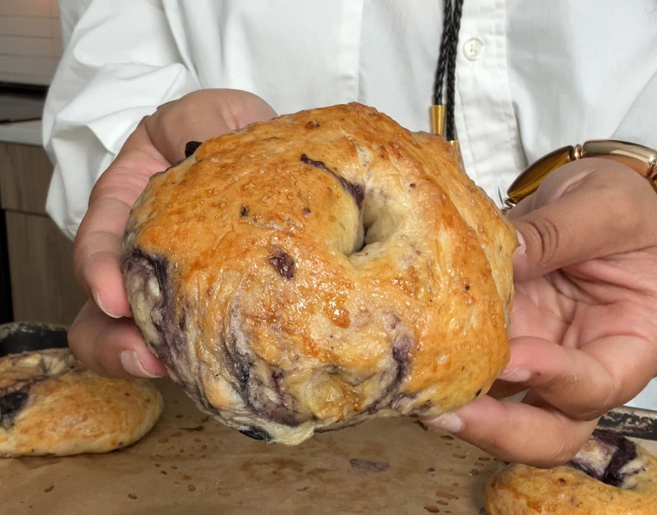 Homemade blueberry bagels with glossy crust and real blueberry streaks - Hungry Mockingbird