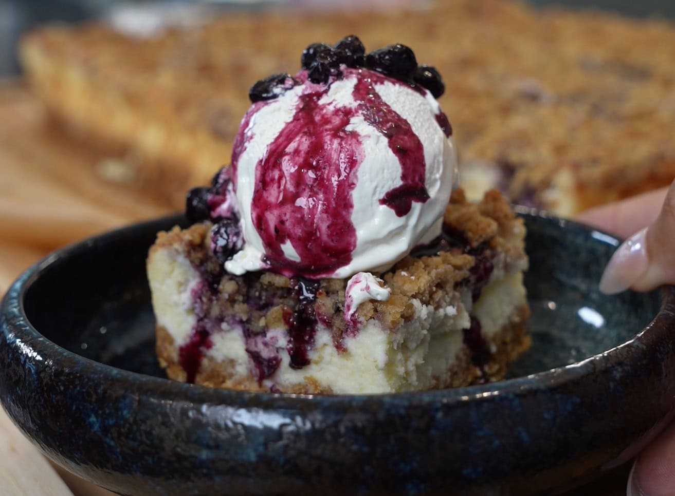Blueberry crumble cheesecake bars with blueberry compote and whipped topping - Hungry Mockingbird