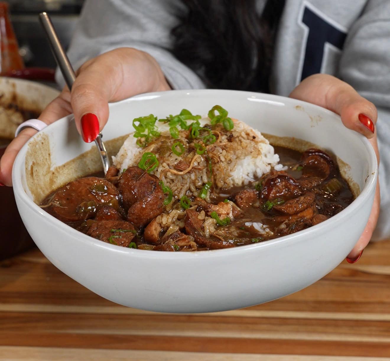 Bowl of dark roux chicken and andouille sausage gumbo over white rice - Hungry Mockingbird