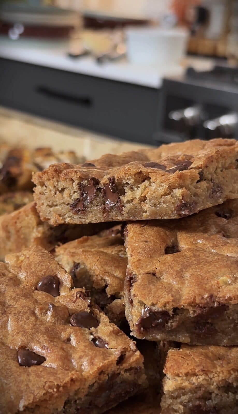 A stack of banana spice chocolate chip blondies with melty chocolate chips