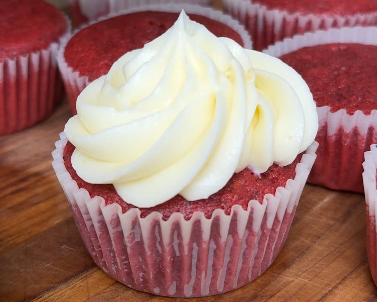 Red velvet cupcakes piped with homemade cream cheese frosting - Hungry Mockingbird