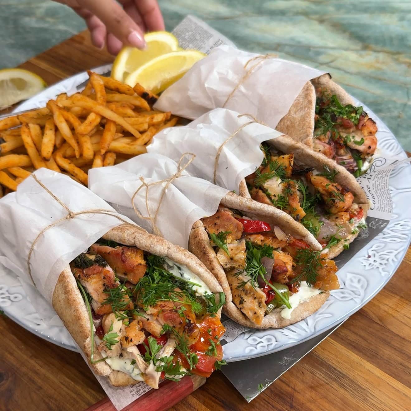 Sheet pan chicken gyro wraps loaded with peppers, onions, fries, and homemade tzatziki - Hungry Mockingbird